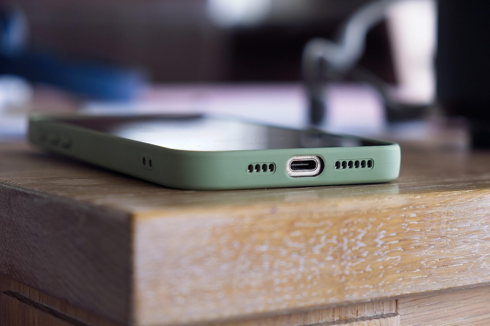 A smartphone resting on a wooden desk